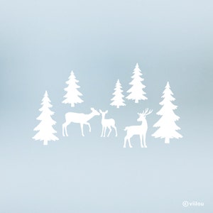 Könnte beinhalten: Weiße Silhouette einer Hirschfamilie mit einem Hirsch, einer Hirschkuh und einem Kitz, die in einem schneebedeckten Wald mit fünf weißen Kiefern stehen.