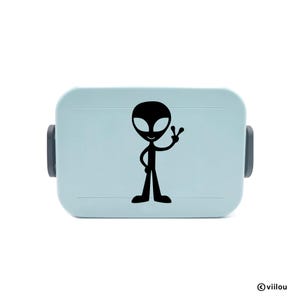 May include: A light blue lunchbox with a black alien graphic. The alien is wearing a peace sign.