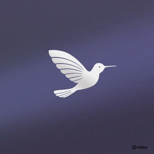 Op de afbeelding: Een witte silhouet van een kolibrie met uitgespreide vleugels tegen een donkerblauwe achtergrond. De vleugels van de vogel zijn gedetailleerd met verschillende gebogen lijnen, wat een eenvoudig en elegant ontwerp oplevert.
