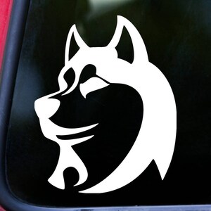 May include: White silhouette of a husky dog's head facing left. The dog's ears are perked up and its eyes are closed. The image is a simple, stylized design.