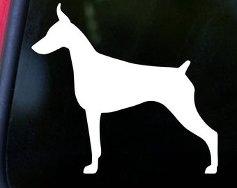 May include: White silhouette of a Doberman Pinscher dog standing on a black background.