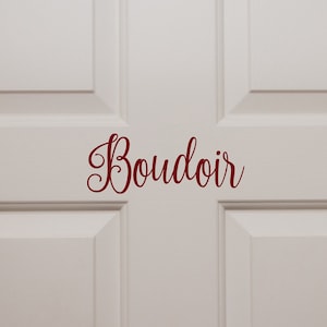 May include: White door with a red cursive inscription that reads "Boudoir".