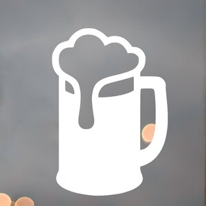 May include: White silhouette of a beer stein with a foamy head on top. The stein has a handle and a rounded bottom.