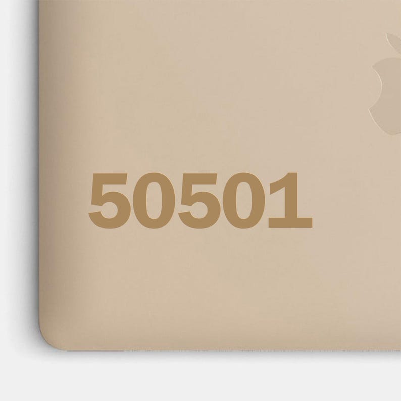 May include: A beige surface with the number "50501" printed in a darker beige color. The corner of a device with an Apple logo is visible in the upper right corner.
