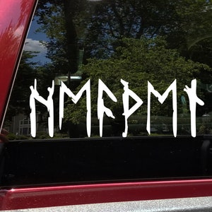 May include: White vinyl decal of the word "NMMFPMM" written in runes on a black car window.