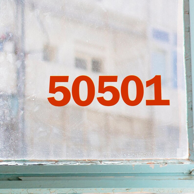 May include: A window with the number "50501" in a bold, orange font. The number is centered on the window, which has a slightly blurred background. The window frame is a faded teal color.