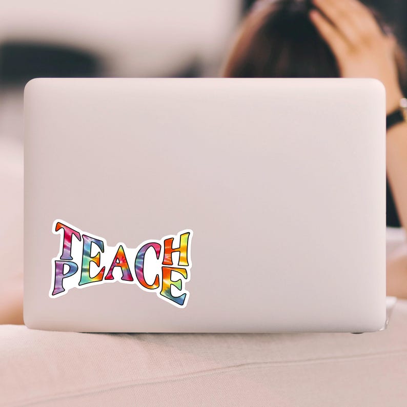 A laptop personalized with a Teach Peace sticker, enhancing the device with a splash of color and a meaningful message.