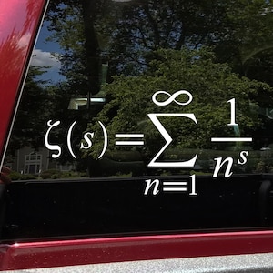 May include: A white vinyl sticker with the mathematical formula for the Riemann zeta function,  ζ(s) = Σ∞n=1 1/ns, on a black background.