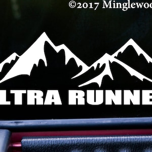 May include: White mountain range graphic with the text "ULTRA RUNNER" on a black background. The image is a decal, likely for a vehicle, promoting ultra running.