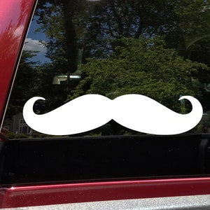 May include: White vinyl decal of a mustache on a red car window.