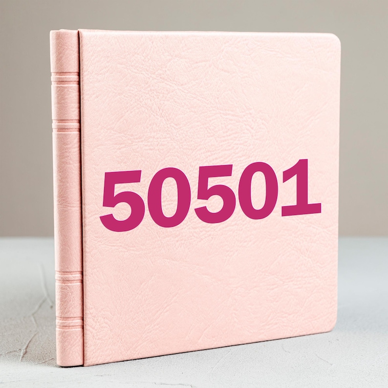 May include: A light pink, leather-bound photo album with the number "50501" printed in a bold magenta font. The album is standing upright, showcasing its textured cover and spine detail.