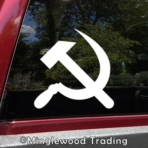 May include: White vinyl sticker of a hammer and sickle, a symbol of communism, on a red car window. The sticker is on a black background.  ©Minglewood Trading