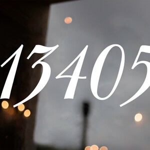 May include: White vinyl number stickers with the number 13405 on a glass door.