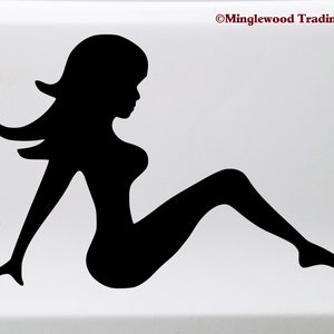 May include: Black silhouette of a woman sitting with her legs crossed. The silhouette is a decal sticker.