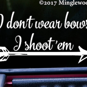 May include: White vinyl decal with an arrow and the text "I don't wear bows I shoot 'em".