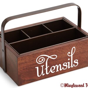 May include: A wooden utensil holder with a metal handle. The holder has five compartments and is labeled "Utensils" in white lettering.