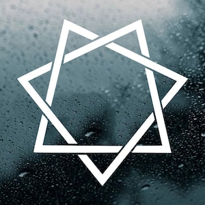 May include: White geometric star design on a dark, water-covered surface. The star is formed by two overlapping triangles, creating a six-pointed star shape. The background is a dark, textured surface with water droplets.