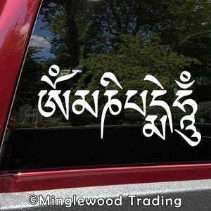 May include: White vinyl sticker with Tibetan script that reads "Om Mani Padme Hum" on a red car window.