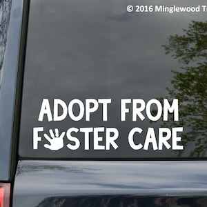 May include: White vinyl decal with the text "Adopt from Foster Care" and a white handprint. The decal is on the back window of a black car.