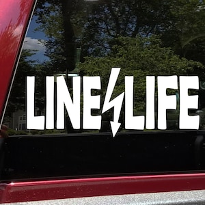 May include: White vinyl decal with the text "LINE LIFE" and a lightning bolt graphic. The decal is on a black background.