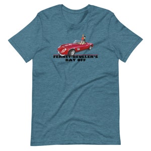 May include: A teal blue t-shirt with a red Ferrari sports car and two figures in the car. The text "Ferris Bueller's Day Off" is printed in black below the car.