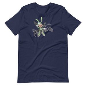 May include: A navy blue t-shirt featuring a cartoon character in a green suit and hat, flying with the text "The Pernoid" in a stylised font.