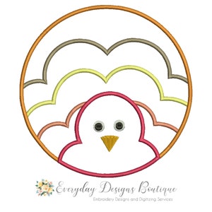 May include: A colourful embroidery design of a turkey with a red head and a yellow beak. The turkey's feathers are represented by a series of overlapping circles in shades of orange, yellow and brown.