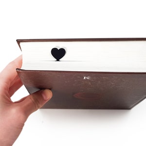 Black metal bookmark Heart. A long flat metal stick stays between the book's pages. The heart is on the side of the book. It is visible even when the book is closed. Made in Ukraine. Not mass manufactured.