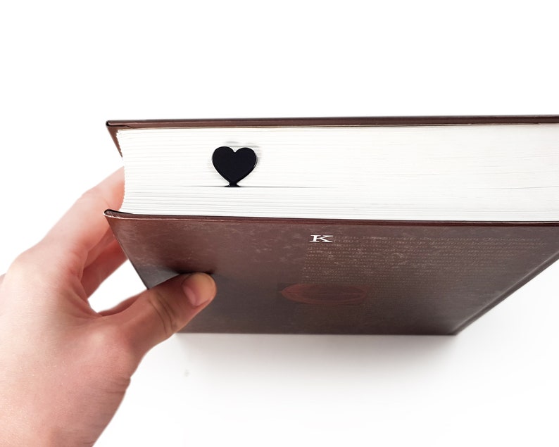 Black metal bookmark Heart. A long flat metal stick stays between the book's pages. The heart is on the side of the book. It is visible even when the book is closed. Made in Ukraine. Not mass manufactured.