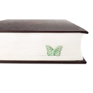 Mint metal bookmark Butterfly. A flat metal stick stays between the pages of the book. The butterfly is on the side of the book. It is visible even when the book is closed. Made in our workshop in Ukraine. Not mass manufactured.