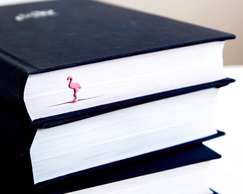 Pink metal bookmark Flamingo. A long, flat metal stick stays between the pages of the book - Cool Bookmark