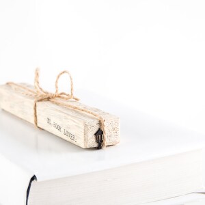 Black metal bookmark Lamp Post on the wooden block.