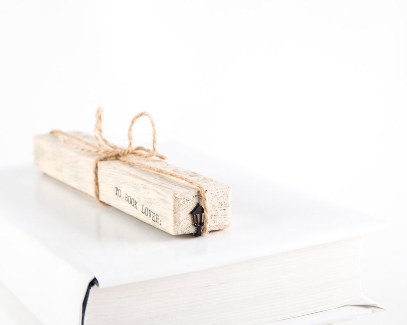 Black metal bookmark Lamp Post on the wooden block.
