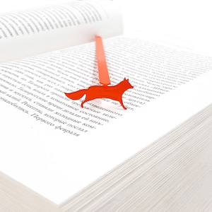 Orange metal bookmark Running Fox. A flat metal stick stays between the pages of the book. The fox is on the side of the book.  It is visible even when the book is closed. Made in our workshop in Ukraine. Not mass manufactured.