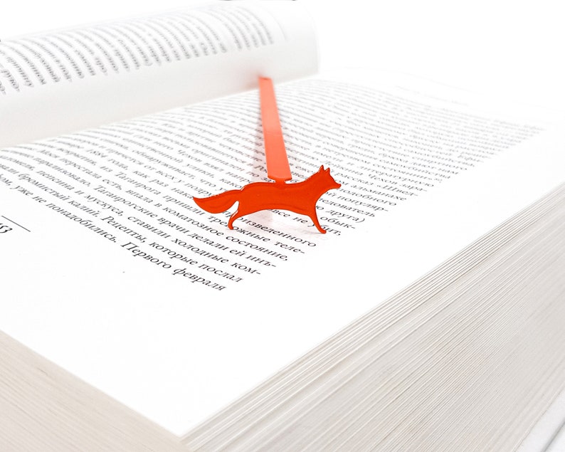Orange metal bookmark Running Fox. A flat metal stick stays between the pages of the book. The fox is on the side of the book.  It is visible even when the book is closed. Made in our workshop in Ukraine. Not mass manufactured.