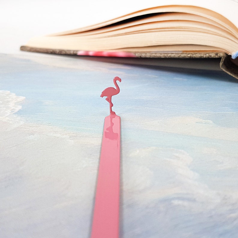 Pink metal bookmark Flamingo. A long, flat metal stick stays between the pages of the book - Cool Bookmark