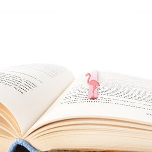 Pink metal bookmark Flamingo. A long, flat metal stick stays between the pages of the book - Cool Bookmark