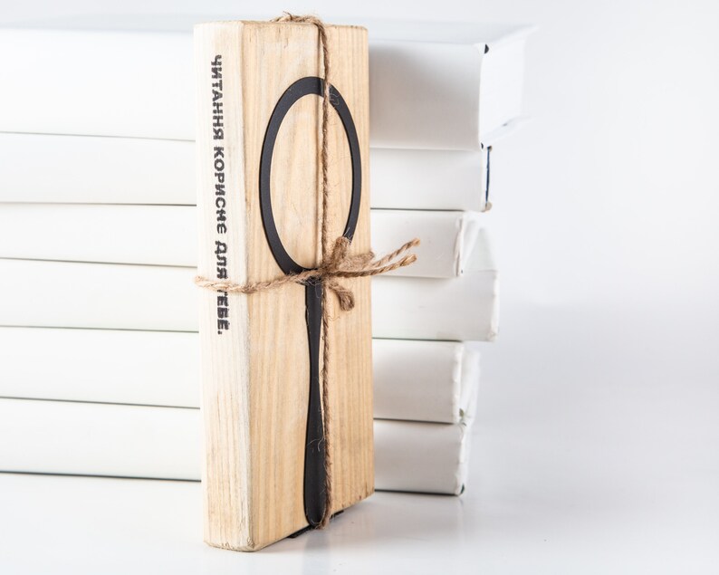 Black metal bookmark Magnifying Glass fastened to the wooden block.