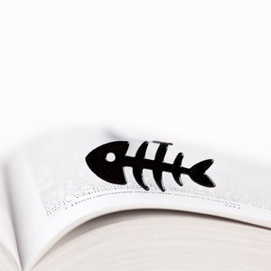 Black metal bookmark fishbone. A flat metal stick stays between the pages of the book. The fishbone is on the side of the book.  It is visible even when the book is closed. Made in our workshop in Ukraine. Not mass manufactured.