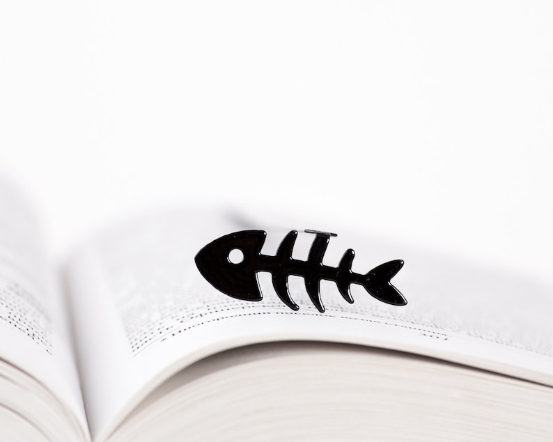 Black metal bookmark fishbone. A flat metal stick stays between the pages of the book. The fishbone is on the side of the book.  It is visible even when the book is closed. Made in our workshop in Ukraine. Not mass manufactured.