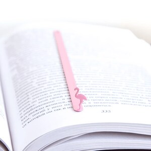 Pink metal bookmark Flamingo. A long, flat metal stick stays between the pages of the book - Cool Bookmark