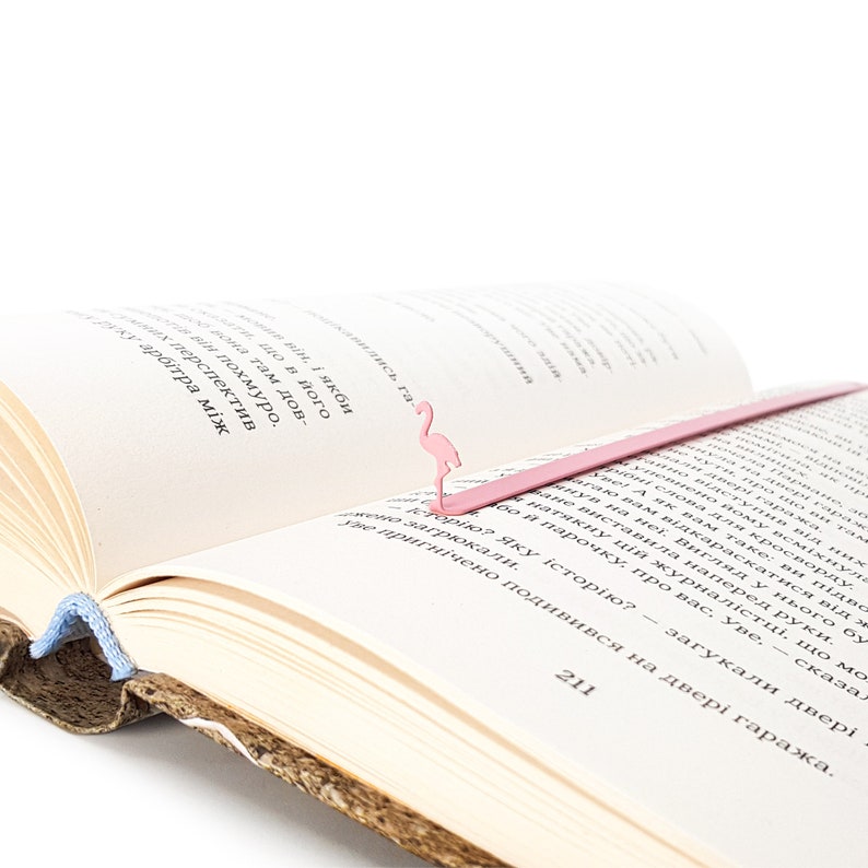 Pink metal bookmark Flamingo. A long, flat metal stick stays between the pages of the book - Cool Bookmark