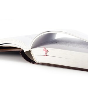 Pink metal bookmark Flamingo. A long, flat metal stick stays between the pages of the book - Cool Bookmark