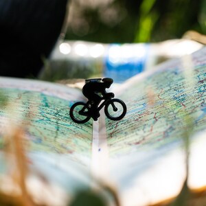 Black metal minimalist style bookmark Bike Racing. The bookmark is  between the pages of the book. Made in our workshop in Ukraine. Not mass manufactured.