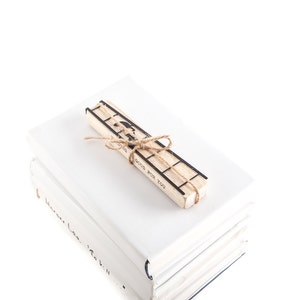 Black metal bookmark Two Cats on the Ladder fastened to the wooden black which says Reading is good for you.