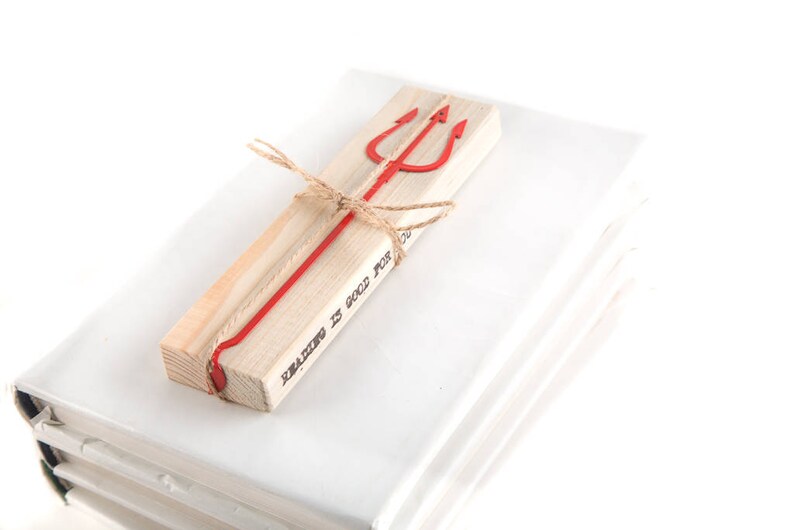 May include: A wooden bookmark with a red metal trident and the text "Reading is good for you".