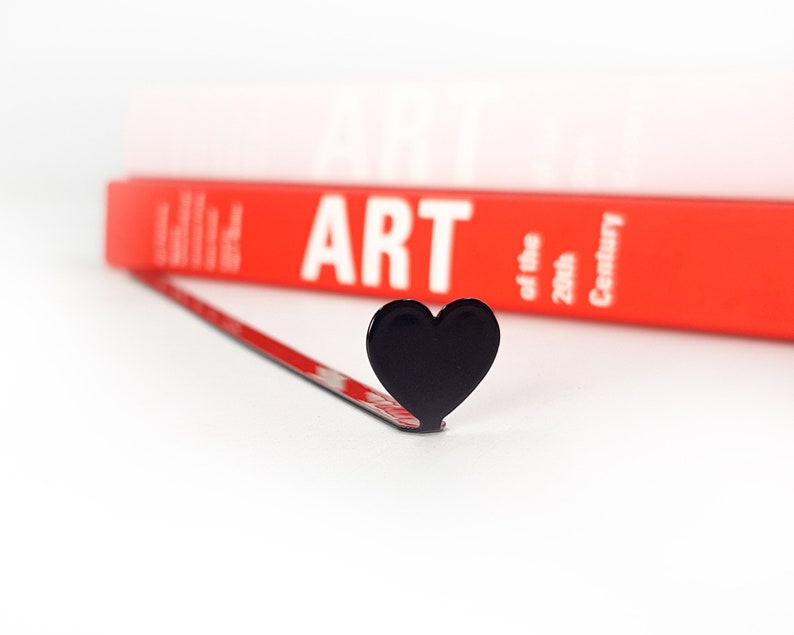 Black metal bookmark Heart. A long flat metal stick stays between the book's pages. The heart is on the side of the book. It is visible even when the book is closed. Made in Ukraine. Not mass manufactured.