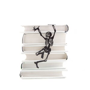 Black Bookmark Happy Reading Skeleton by Coolbookmark on Etsy. It's the perfect gift for horror book lovers with a sense of humor. It's also a Great Skeleton party favor. Unique, eco-friendly gift packaging is ready to give.