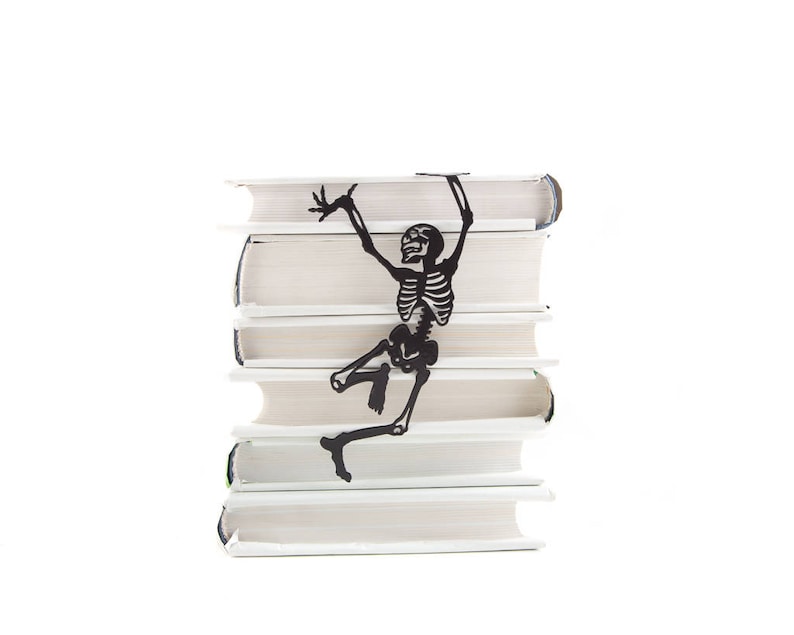 Black Bookmark Happy Reading Skeleton by Coolbookmark on Etsy. It's the perfect gift for horror book lovers with a sense of humor. It's also a Great Skeleton party favor. Unique, eco-friendly gift packaging is ready to give.