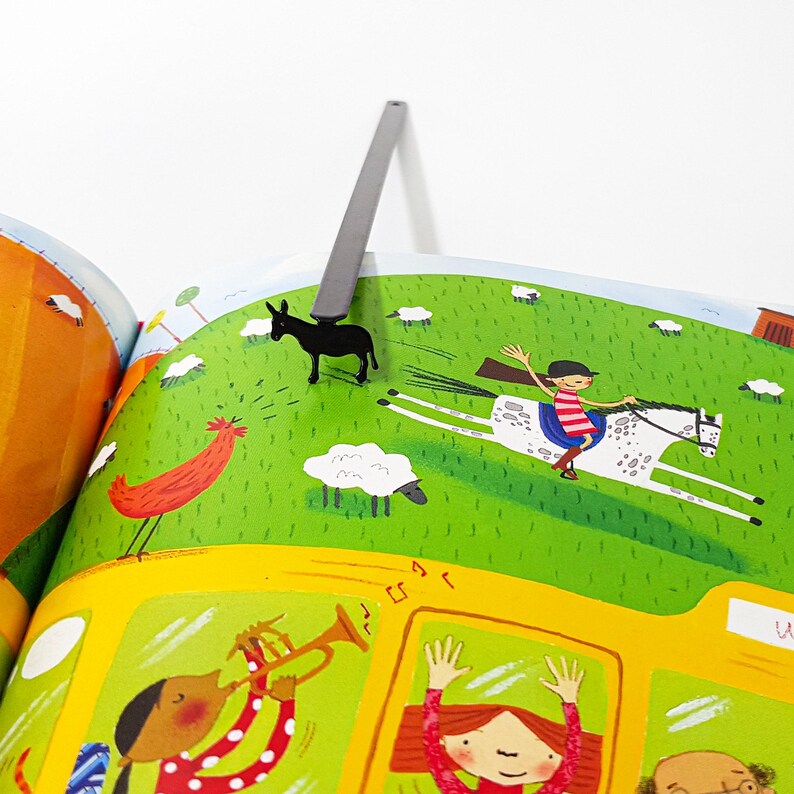 Black donkey bookmark clipped inside open children's farm illustration book